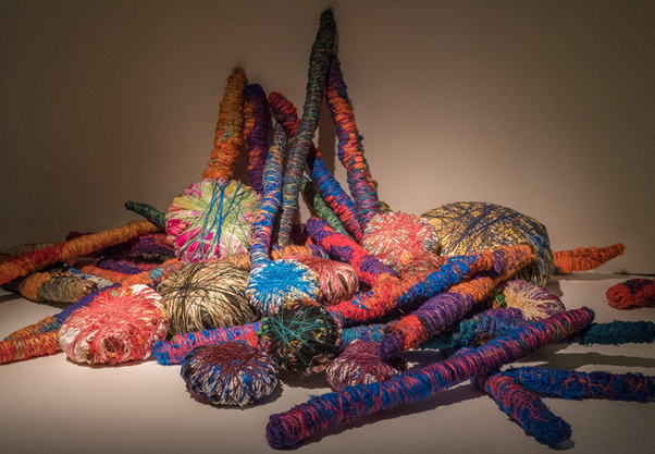 How did Sheila Hicks merge textile art and design to highlight cultural heritage?